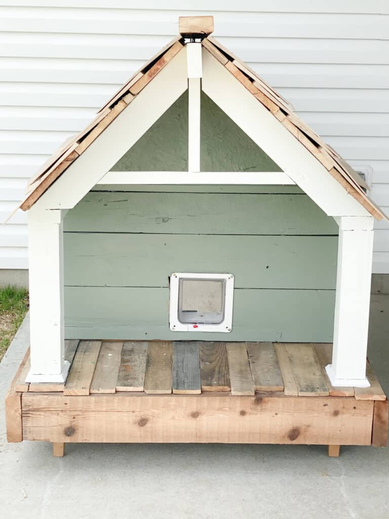 craftsman cat house with cedar shake roof, green pain and white columns and gable built by fearless diy