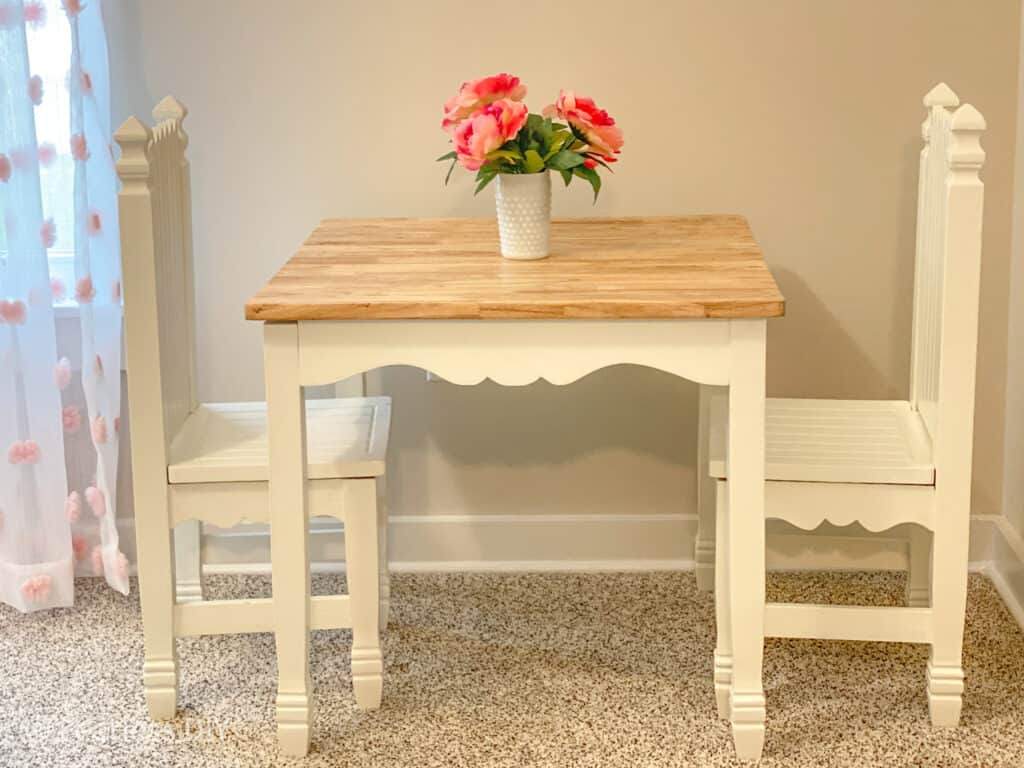 Childs table and chair set legs painted white, top natural finish with pink flowers on top refinished by fearlessdiy 