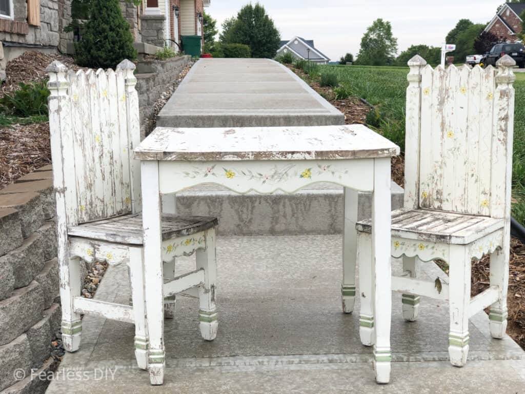 worn out childs table and chairs with chippy paint and rough edges