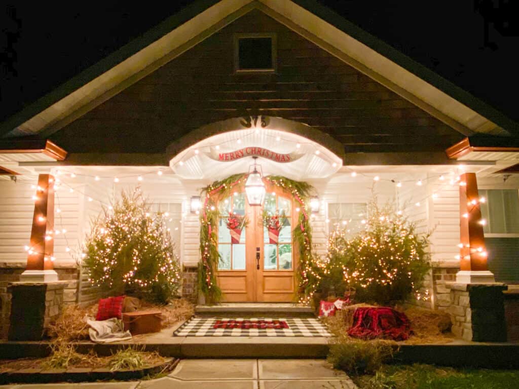 Twinkling lights on a front porch decorated for Christmas by fearlessdiy
