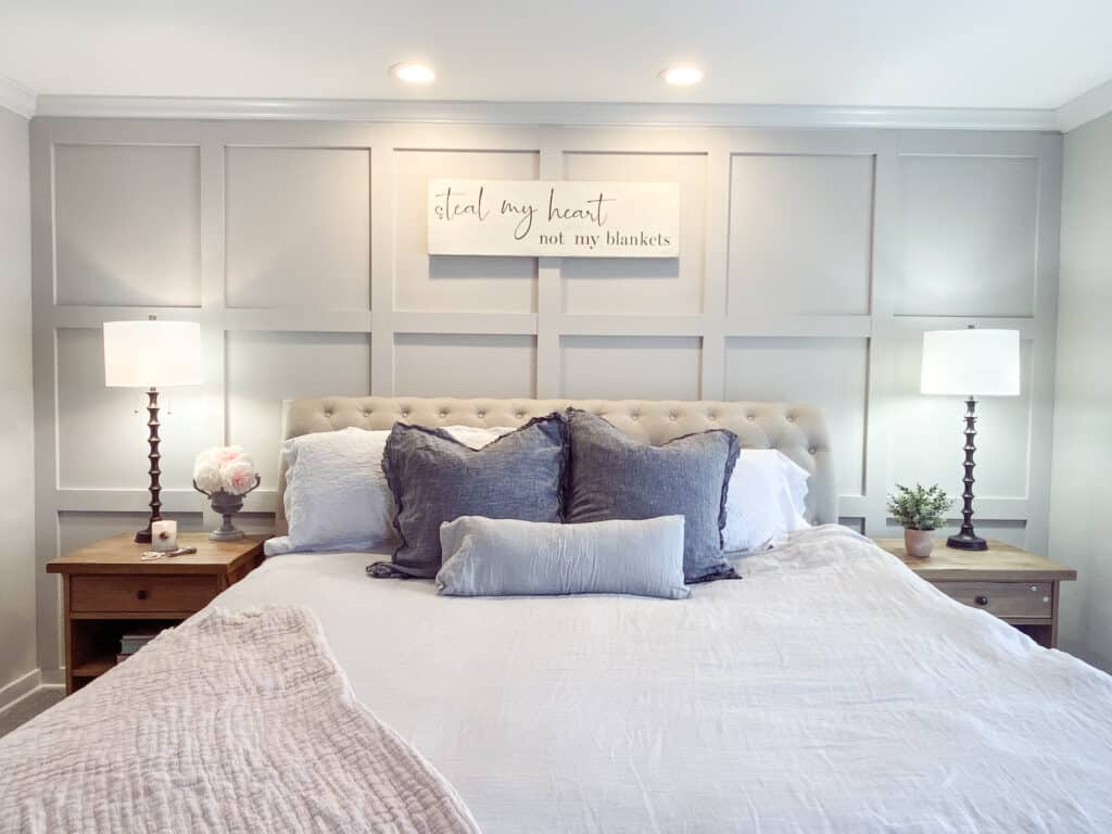 DIY board and batten wall in master bedroom with tufted headboard