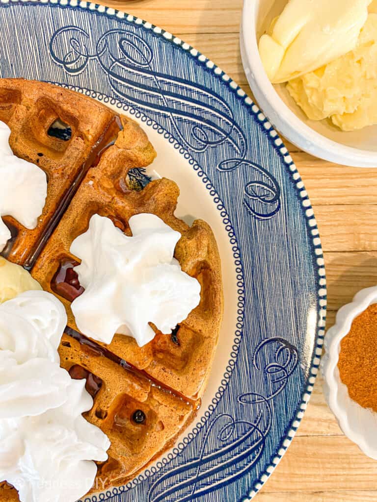 pumpkin spice waffle with syrup butter and whipped topping