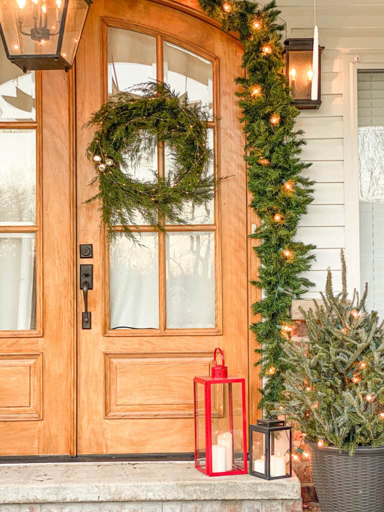 fresh evergreen wreath on a wooden double front door